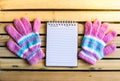 Notepad with glove on wood board background.using wallpaper for education, business photo.Take note of the product for book with p Royalty Free Stock Photo