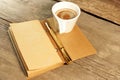 Notepad, Gold Pen, Cup of Coffee on Wooden Table