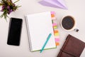 Notepad on the grey working table with phone and coffee. Blank white paper on working desk Royalty Free Stock Photo