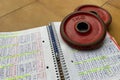 Notepad with handwritten training routine, along with two 1 kilo weight discs.