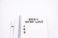 Notepad inscripted 2021 to do list with a pen on a white background close up Royalty Free Stock Photo