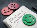 Notepad with inscription emotional regulation and smiley.