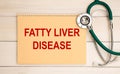 Notepad with the inscription FATTY LIVER DISEASE and stethoscope