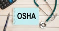 Notepad with the inscription OSHA and stethoscope