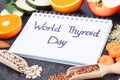 Notepad with inscription World Thyroid Day and best food containing vitamins for healthy thyroid
