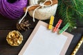 Notepad lays on the wooden background to make a list to do things or list of presents for friends and family. New year