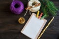 Notepad lays on the wooden background to make a list to do things or list of presents for friends and family.