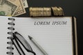 Notepad with Lorem ipsum words, pencil, glasses