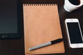 Notepad on an office desk, coffee and electronic gadgets, phone, tablet Royalty Free Stock Photo