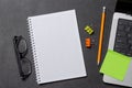 Notepad, office supplies and laptop on black leather workspace, top view with copy space Royalty Free Stock Photo