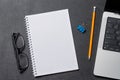 Notepad, office supplies and laptop on black leather workspace, top view with copy space Royalty Free Stock Photo