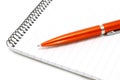 Notepad with orange ball pen Royalty Free Stock Photo