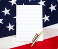 Notepad with pen on the american flag. Top view