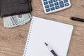 notepad with pen, calculator, dollar bills Royalty Free Stock Photo