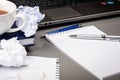 Notepad, pen, crumpled sheets of paper on the desk Royalty Free Stock Photo