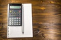 Notepad with pencil and calculator on a wooden desk Royalty Free Stock Photo