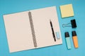 notepad, pencil, eraser, colored pencils, clips and note paper. back to school. Isolated blue background Royalty Free Stock Photo