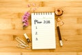 Notepad with pencil and Plan 2018 text on a wooden table , ove Royalty Free Stock Photo