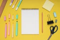 Notepad, scissors, pencil, sharpener, ruler, eraser, colored pencils, clips and note paper. back to school. Isolated yellow Royalty Free Stock Photo