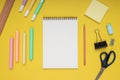 notepad, scissors, pencil, sharpener, ruler, eraser, colored pencils, clips and note paper. back to school. Isolated yellow Royalty Free Stock Photo