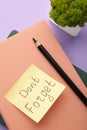 Notepad and sticky notes with word don`t forget on purple background Royalty Free Stock Photo