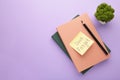 Notepad and sticky notes with word don`t forget on purple background Royalty Free Stock Photo