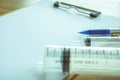 Notepad and syringe or injection