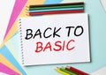 The Notepad with the text Back To Basic is on colored paper with color pencils Royalty Free Stock Photo