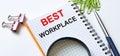 Notepad with text Best Workplace on white background with clips, pen and magnifying glass Royalty Free Stock Photo