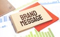 Notepad with text BRAND MESSAGE. Diagram, red notepad and white background Royalty Free Stock Photo