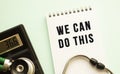 Notepad with text WE CAN DO THIS, calculator and stethoscope on white background. Royalty Free Stock Photo