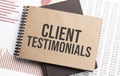 Notepad with text Client Testimonials on a charts and numbers. Business concept Royalty Free Stock Photo
