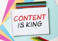 The Notepad with the text Content Is King is on colored paper with color pencils Royalty Free Stock Photo