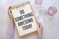 Do something awesome today on granite white background Royalty Free Stock Photo