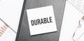 Notepad with text durable on a charts and numbers. Business concept Royalty Free Stock Photo