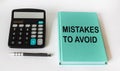 Notepad with text errors to avoid with a calculator on a white background. Can be used as concept photo Royalty Free Stock Photo