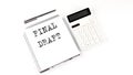 Notepad with text FINAL DRAFT with calculator and pen. White background. Business Royalty Free Stock Photo