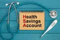 Notepad with text Health Savings Account HSA and stethoscope