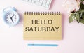 The Notepad with the text Hello Saturday is on colored paper with color pencils. Royalty Free Stock Photo