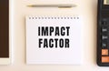 Notepad with text IMPACT FACTOR on a white background. Business concept Royalty Free Stock Photo