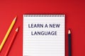 Notepad with text Learn a New Language Royalty Free Stock Photo