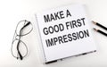 Notepad with text MAKE A GOOD FIRST IMPRESSION . White background. Business concept Royalty Free Stock Photo