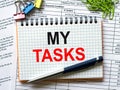Notepad with text My Tasks on white background with paper clips and pen Royalty Free Stock Photo