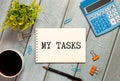 Notepad with text My Tasks on white background with paper clips and pen. Royalty Free Stock Photo