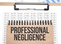 Notepad with text PROFESSIONAL NEGLIGENCE on a charts and numbers. Business concept Royalty Free Stock Photo