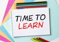 The Notepad with the text Time To Learn is on colored paper with color pencils Royalty Free Stock Photo