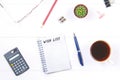 Notepad with text: wish list. White table with calculator, cactus, note paper, coffee mug, pen, glasses. Royalty Free Stock Photo