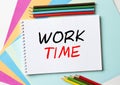The Notepad with the text Work Time is on colored paper with color pencils Royalty Free Stock Photo