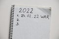 Notepad with the text of the year 2021 and 2022. Plans for the year 2022 war in Ukraine. All forces to win the war Royalty Free Stock Photo
