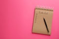Notepad with unfilled To Do list and pen on pink background, top view. Space for text